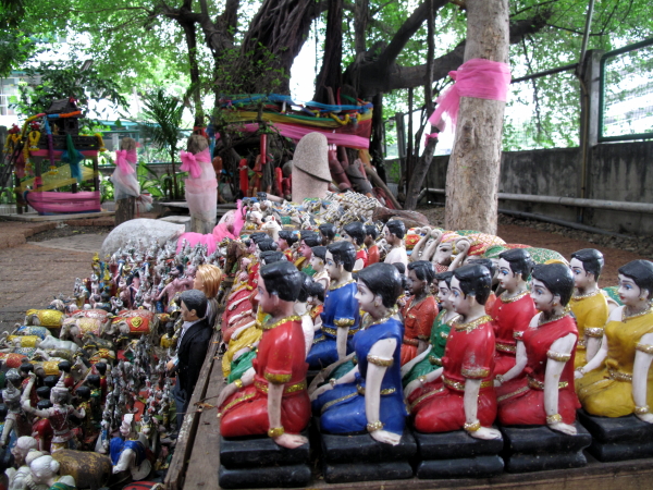 Hundreds of tiny figurines left near the spirit house