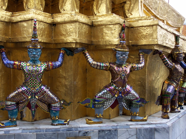 Colorful demons supporting a stupa