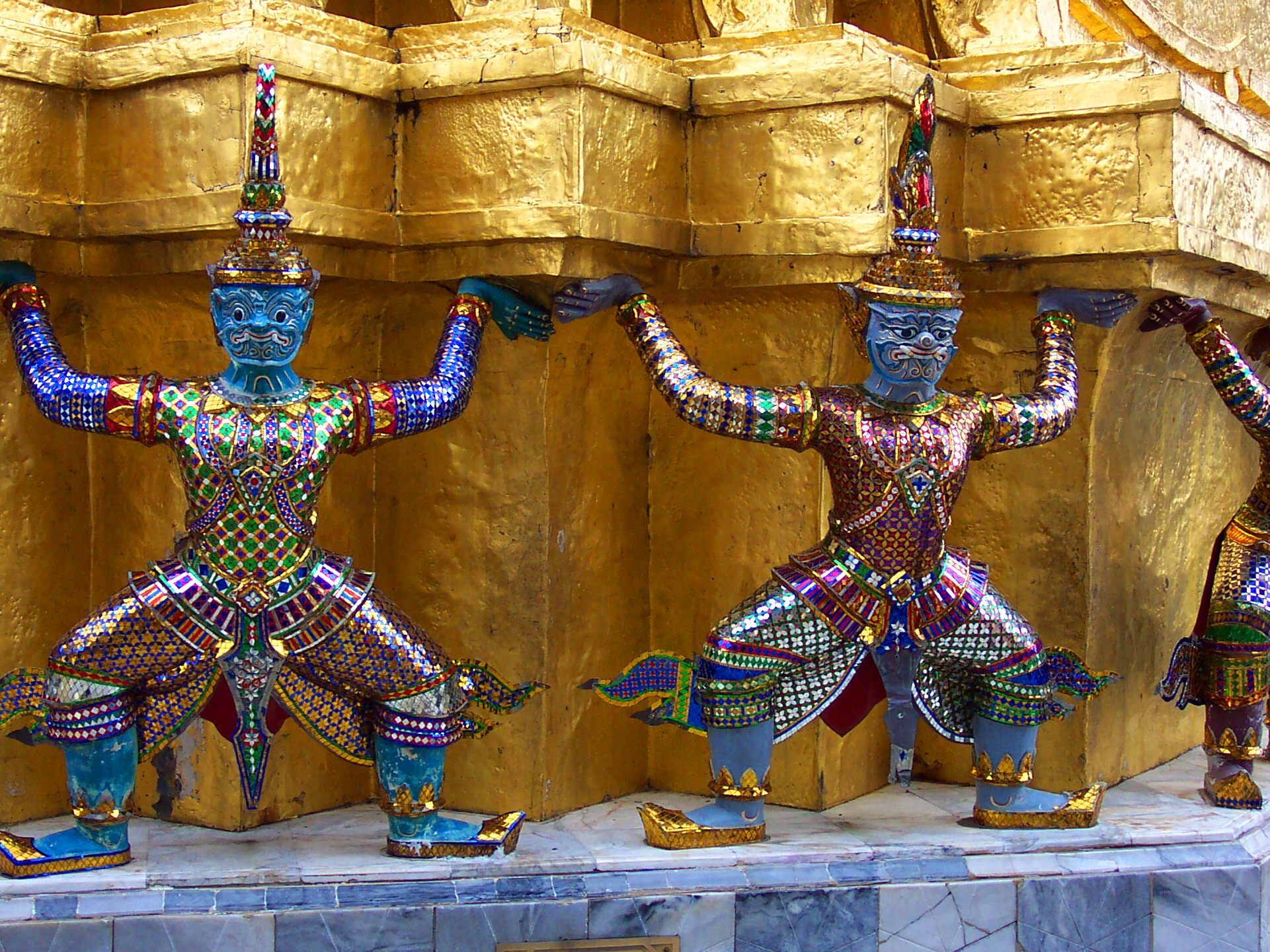 Colorful demons supporting a stupa